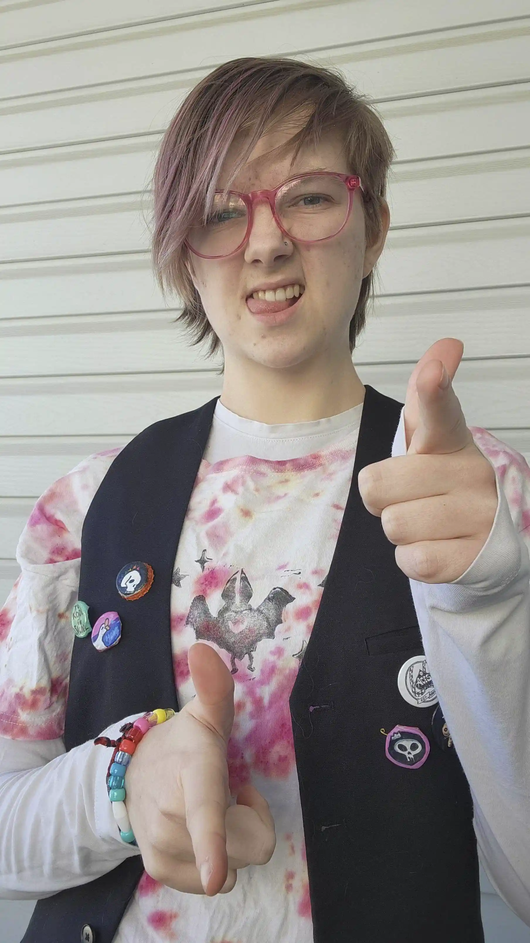 kayden making finger guns and a charming face